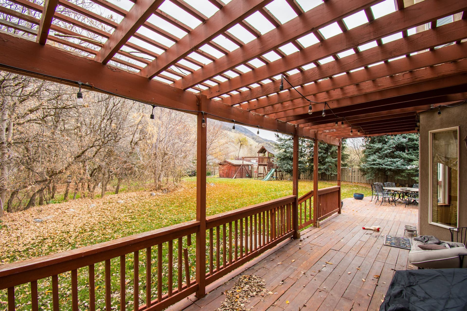 Covered pergola over a wooden deck overlooking a Maryland back yard